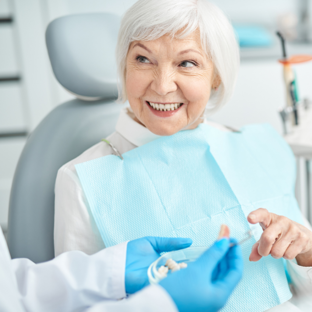 Mature woman sitting in dental chair for denture assessment.